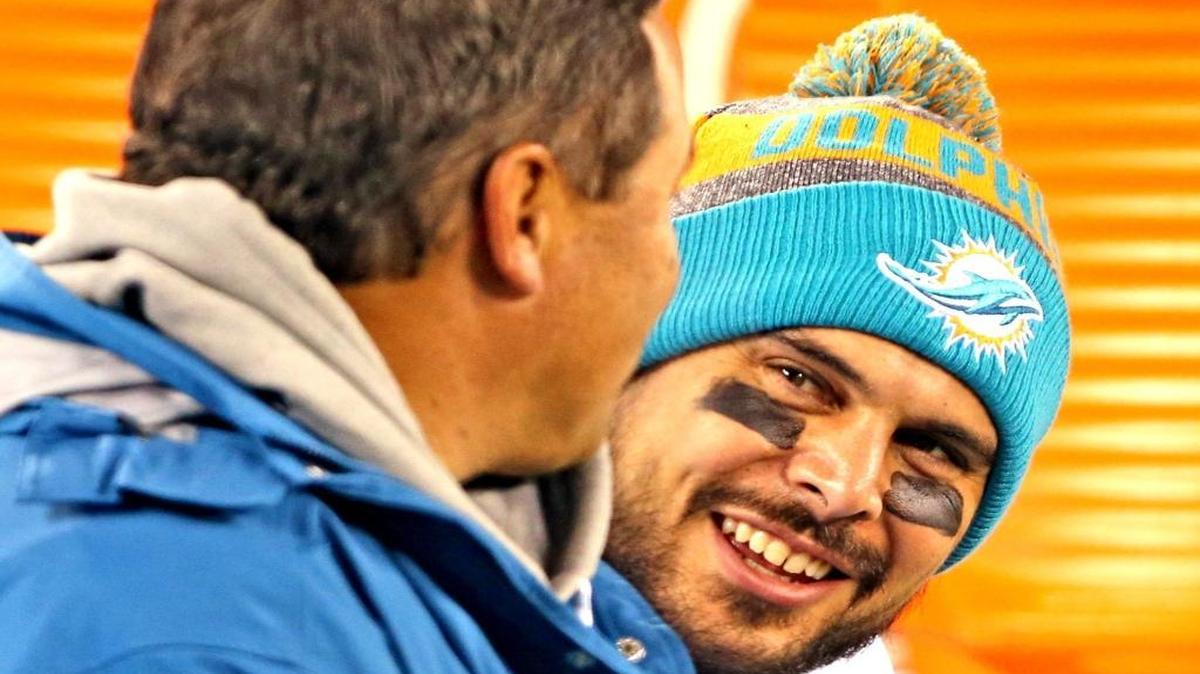 Clyde Christensen, left, and Matt Moore share a laugh during the Dolphins’ beatdown of the Jets.