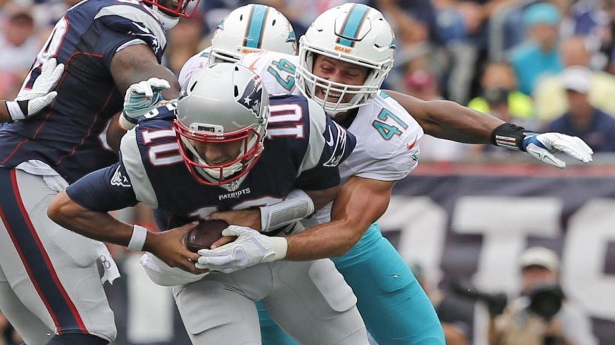 Miami Dolphins linebacker Kiko Alonso (47) attempts to tackle New England Patriots quarterback Jimmy Garoppolo (10) in the first quarter as the New England Patriots host the Miami Dolphins at Gillette Stadium on Sunday, September 18, 2016.
