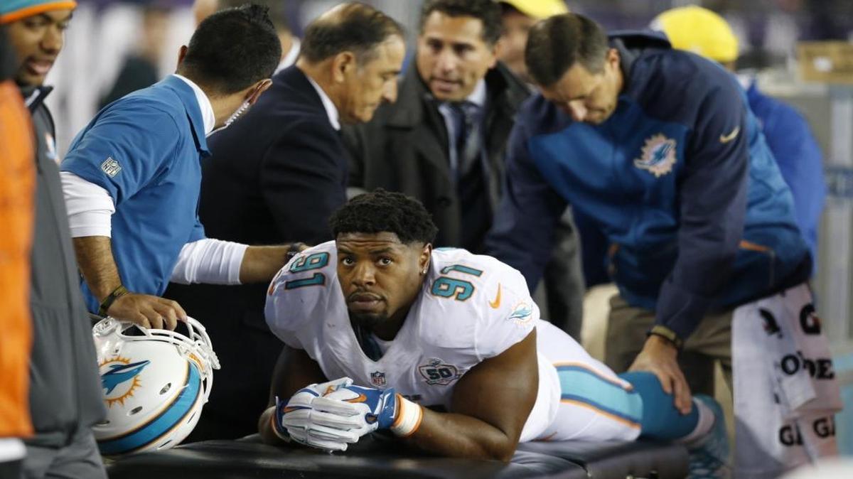 Miami Dolphins defensive end Cameron Wake (91) is checked on by doctors in the fourth quarter as the New England Patriots host the Miami Dolphins at Gillette Stadium in Foxborough, Massachusetts on Thursday, October 29, 2015.