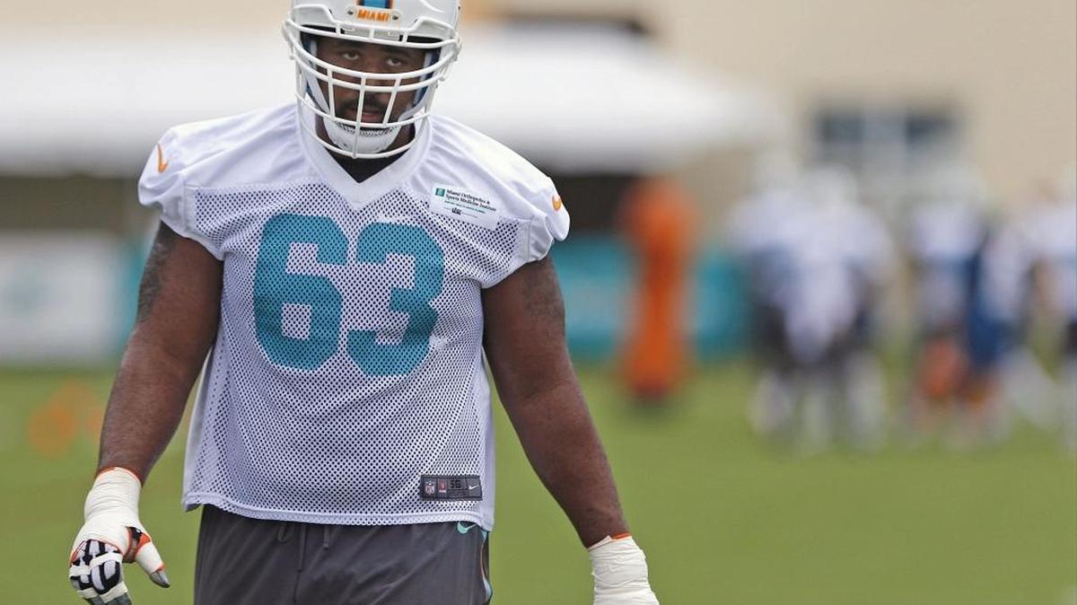 Dallas Thomas walks off the field during offensive line drills. Miami Dolphins held early morning practice at their training facility in Davie on Sunday, August 14, 2016.