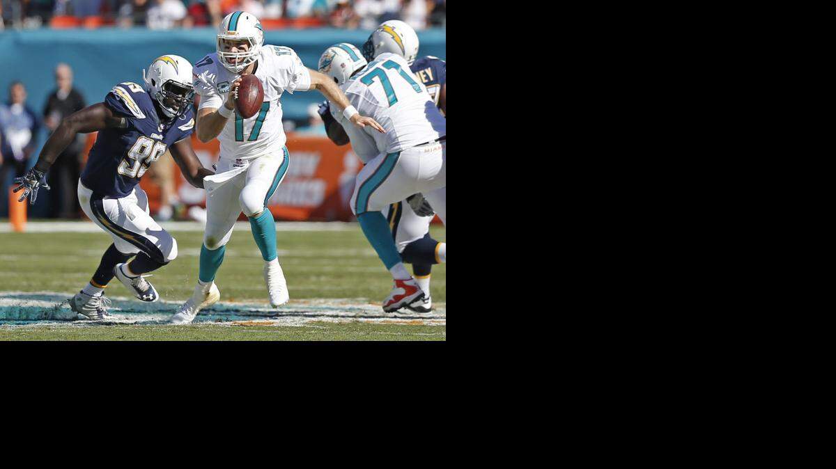 
Miami Dolphins quarterback Ryan Tannehill (17) scrambles out of the pocket for a first down in the second quarter against the San Diego Chargers at Sun Life Stadium on Sunday, Nov. 2, 2014.
