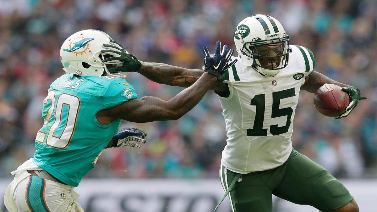 New York Jets' Brandon Marshall, right, fends off Miami Dolphins' Reshad Jones during the NFL football game between the New York Jets and the Miami Dolphins and at Wembley stadium in London, Sunday, Oct. 4, 2015.
