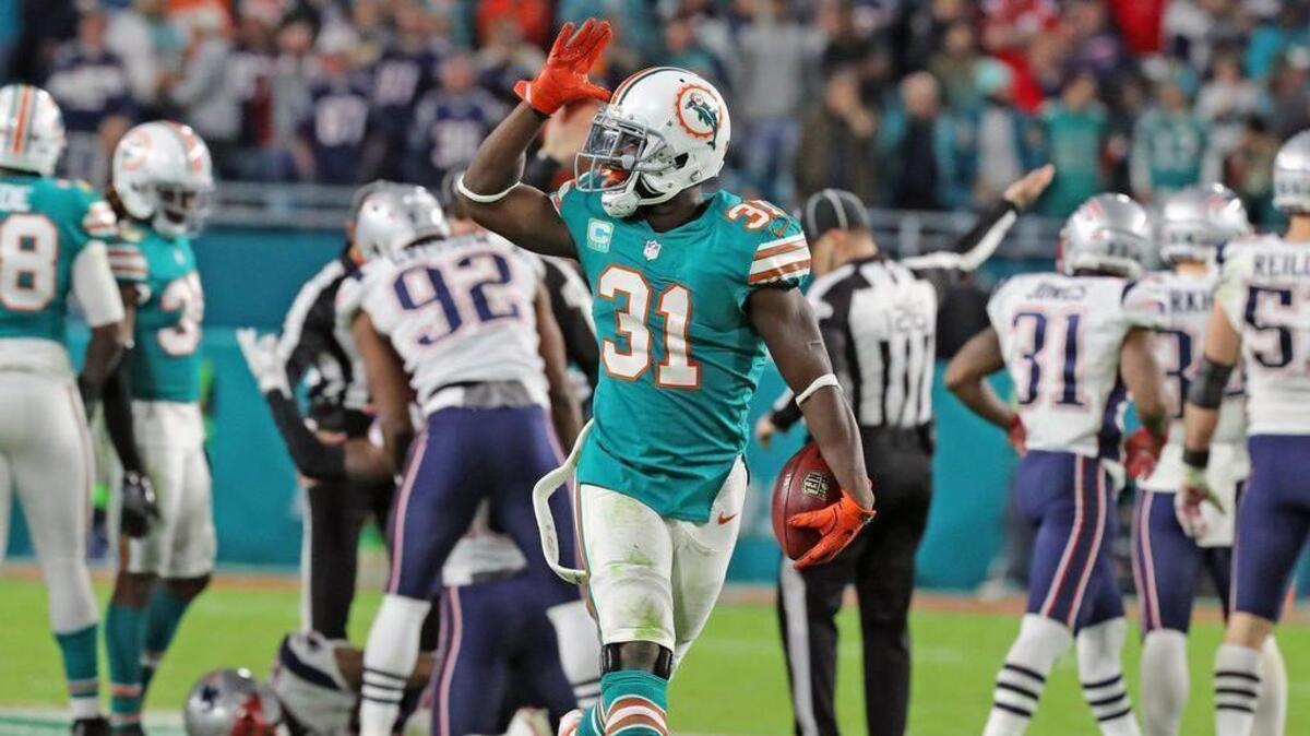 Miami Dolphins Michael Thomas (31) celebrates after recovering an on-side kick in the final seconds of the fourth quarter as hey play the New England Patriots at Hard Rock Stadium in Miami Gardens, Florida, Dec. 11, 2017.