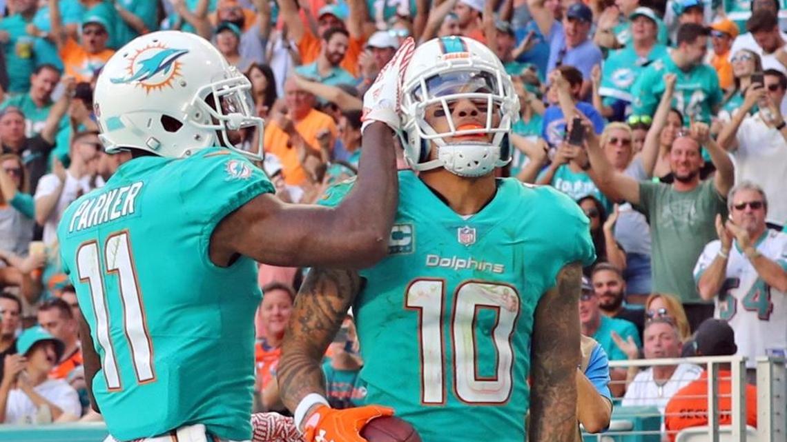 Miami Dolphins DeVante Parker (11) congrats Kenny Stills (10) after a fourth quarter touchdown as they play the Denver Broncos at Hard Rock Stadium in Miami Gardens, Florida, Dec. 3, 2017.