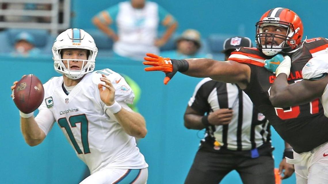 Miami Dolphins quarterback Ryan Tannehill eludes Cleveland Browns Gabe Wright in the second quarter at the Hard Rock Stadium in Miami Gardens, Florida, Sun., Sept. 25, 2016.