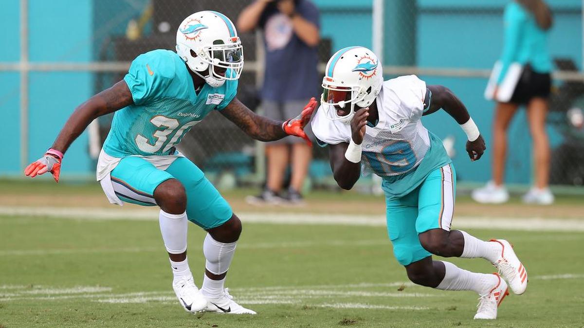 Miami Dolphins cornerback Cordrea Tankersley (30) follows receiver Jakeem Grant (19) during a training camp practice last week. The Dolphins will try to find an offensive role for Grant even though they have four other established veteran receivers.