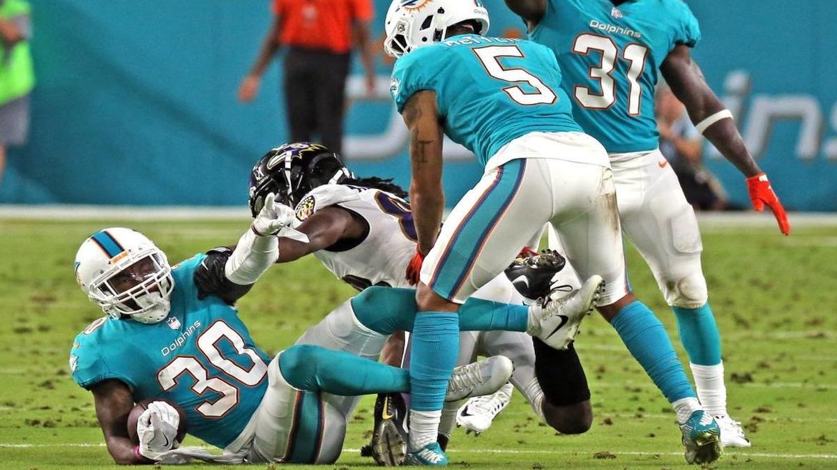 Dolphins Cordrea Tankersley (30) intercepts a pass from Ravens Quincey Adeboyejo (88) in the second quarter as the Miami Dolphins play the Baltimore Ravens in their second preseason game at Hard Rock Stadium in Miami Gardens, FL, Aug. 17, 2017.