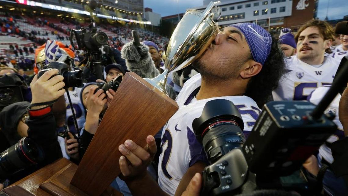 Washington defensive lineman Vita Vea kisses the Apple Cup trophy after Washington beat Washington State in November.