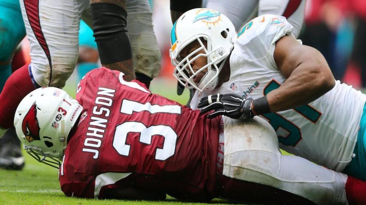 Arizona Cardinals running back David Johnson, shown being tackled vs. Dolphins in a game late in 2016 season, may be one reason to watch an otherwise dreadful Broncos-Cardinals matchup this Thursday night.