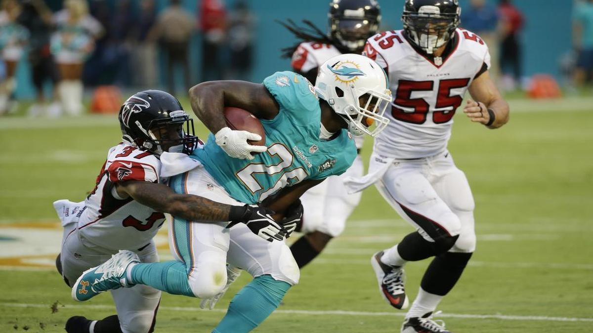 
Miami Dolphins running back Lamar Miller (26) is tackles by Atlanta Falcons cornerback Ricardo Allen (37) during the first half of an NFL pre season football game, Saturday, Aug. 29, 2015 in Miami Gardens, Fla. 
