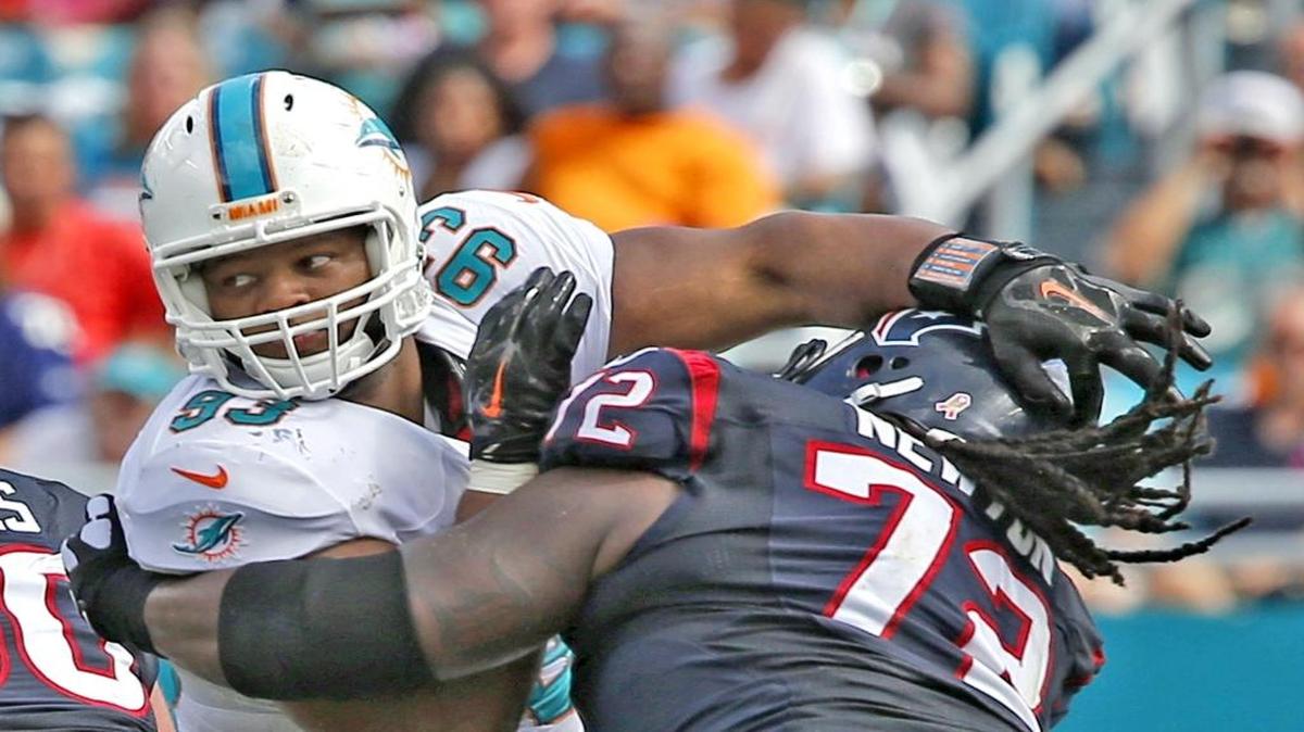 Miami Dolphins defensive tackle Ndamukong Suh tries to get around Houston Texans offensive lineman Derek Newton in the second quarter of their game at Sun Life Stadium in Miami Gardens on October 25, 2015.
