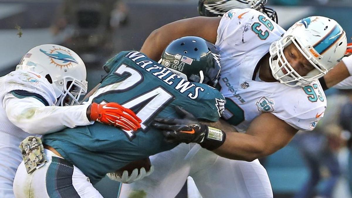 Miami Dolphins Reshad Jones and Ndamukong Suh tackle Philadelphia Eagles Ryan Mathews in the third quarter at Lincoln Financial Field in Philadelphia, Penn., November 15, 2015.