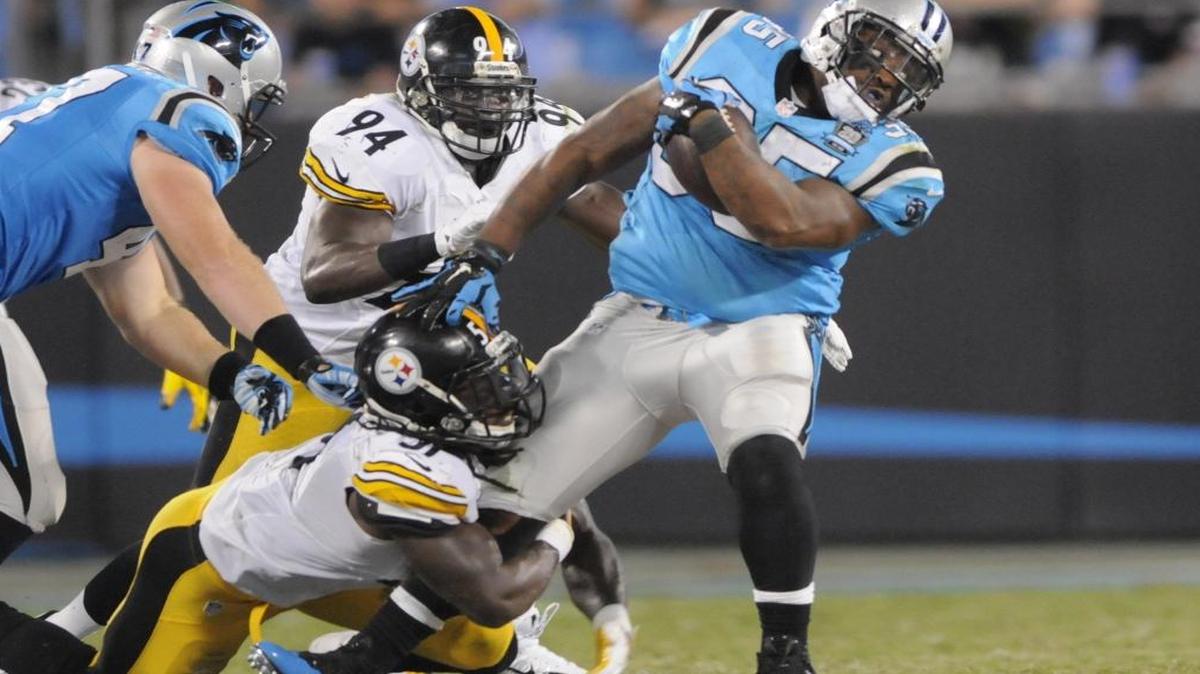 Carolina Panthers' Mike Tolbert (35) is tackled by Pittsburgh Steelers' Sean Spence (51) on Sept. 21, 2014. Spence met with the Dolphins Saturday.