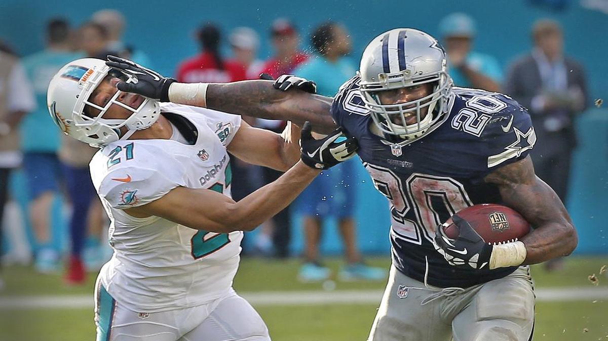 Miami Dolphins Brent Grimes gets stiff-armed by Dallas Cowboys Darren McFadden in the fourth quarter at Sun Life Stadium in Miami Gardens, Florida, November 22, 2015.