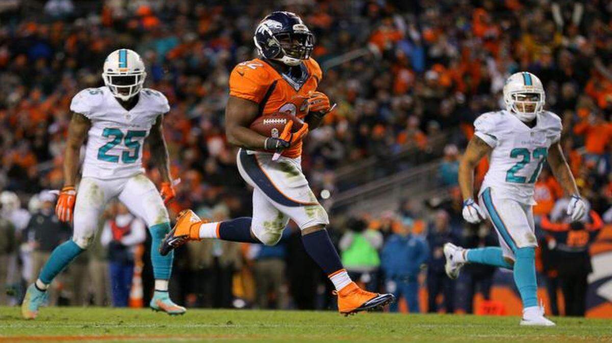 
Running back C.J. Anderson of the Denver Broncos scores against the Miami Dolphins at Sports Authority Field at Mile High on Nov. 23, 2014 in Denver. 
