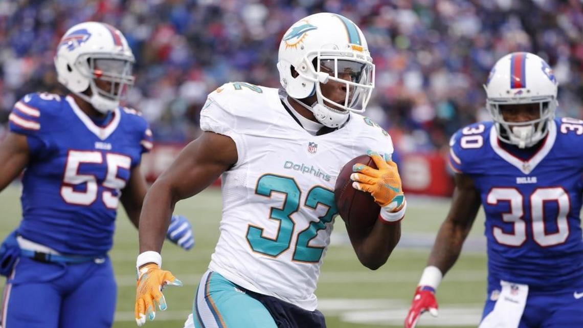 Miami Dolphins running back Kenyan Drake (32) runs in to score in the second quarter as the Buffalo Bills host the Miami Dolphins at New Era Field in Orchard Park, NY on Saturday, December 24, 2016.