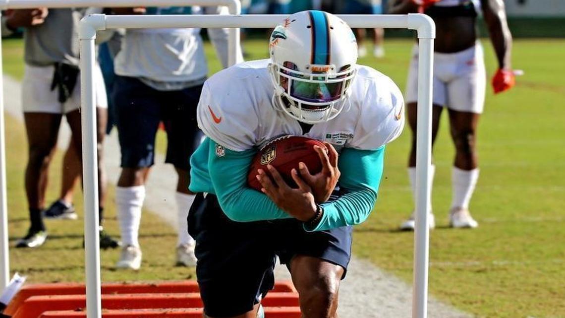 Kenyan Drake goes through drills Monday morning. Later in practice, he left with an apparent head injury.