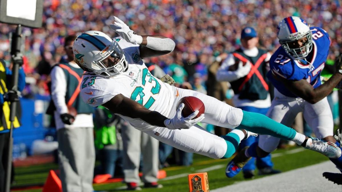 Dolphins running back Jay Ajayi is pushed out of bounds at the 1-yard line by the Bills’ Duke Williams in the second half last Sunday.