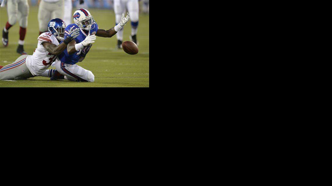 Buffalo Bills wide receiver T.J. Graham (11) can't reach the ball on a pass under pressure from New York Giants cornerback Zack Bowman (31) in the second quarter of the Pro Football Hall of Fame exhibition NFL football game Sunday, Aug. 3, 2014, in Canton, Ohio.