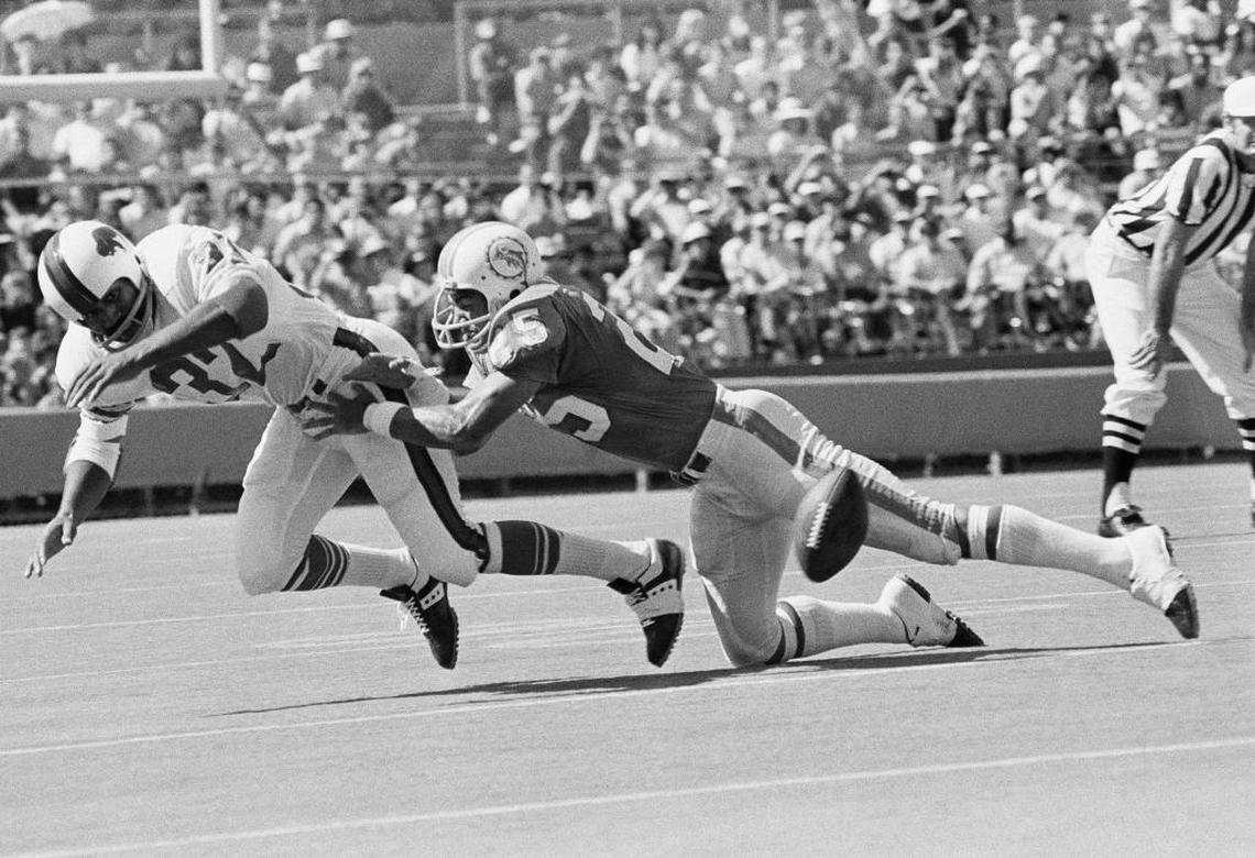 O.J. Simpson of the Buffalo Bills fumbles as hes hit by Tim Foley of the Miami Dolphins, right, in first quarter of game in the Orange Bowl in Miami, on Sunday, Nov. 7, 1971. Jim Riley of the Dolphins recovered.