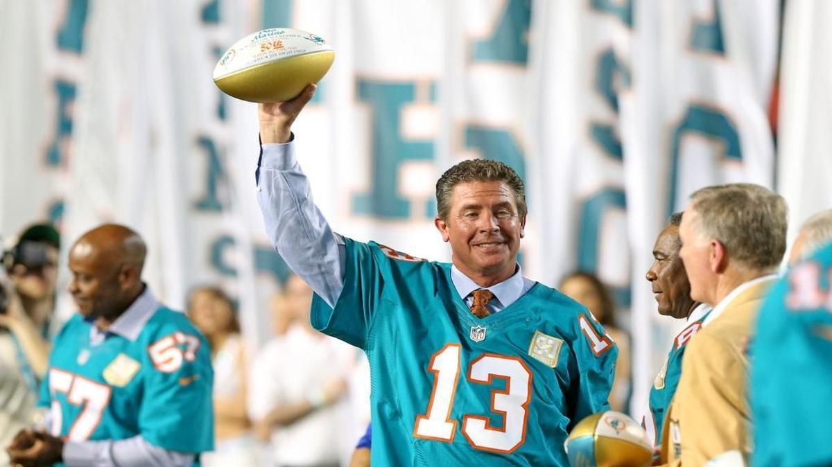 Former Miami Dolphins quarterback Dan Marino holds his ball after being introduced during the halftime presentation as the Fins play the New York Giants at Sun Life Stadium in Miami Gardens on December 14, 2015.