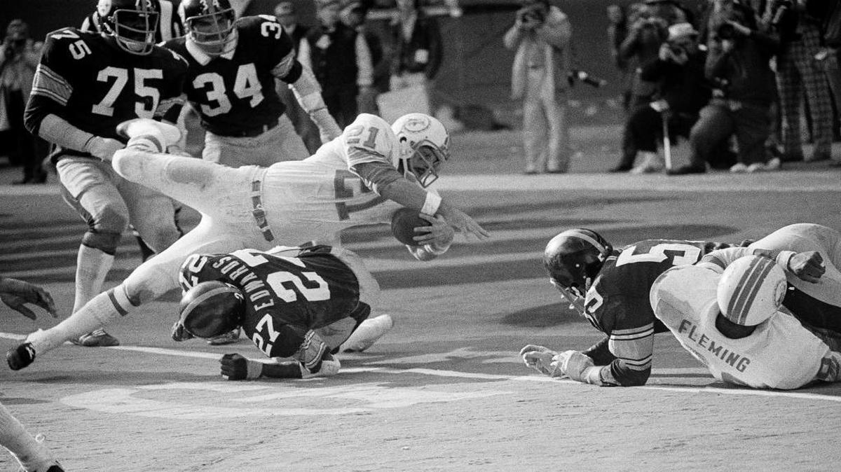 Jim Kiick of the Miami Dolphins goes head first over Glen Edwards of the Pittsburgh Steelers as he scores in the third quarter of their AFC championship game at Three Rivers Stadium in Pittsburgh, Pa., Dec. 31, 1972. The Dolphins won 21-17.