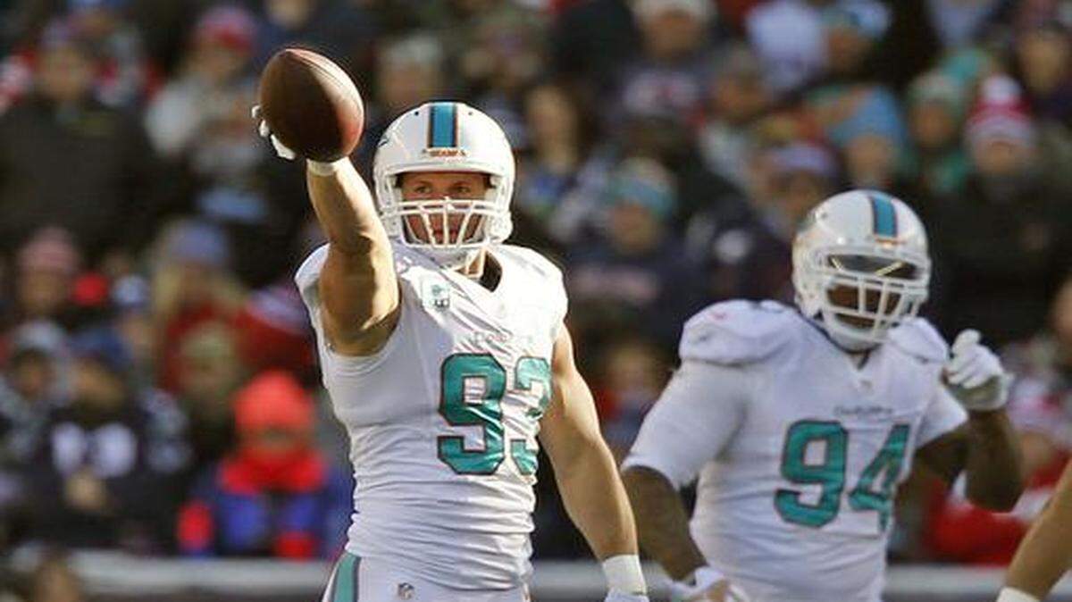
Miami Dolphins middle linebacker Jason Trusnik (93) signals Miami ball after intercepting a pass in the first quarter as the New England Patriots host the Miami Dolphins at Gillette Stadium on Sunday, Dec. 14, 2014
