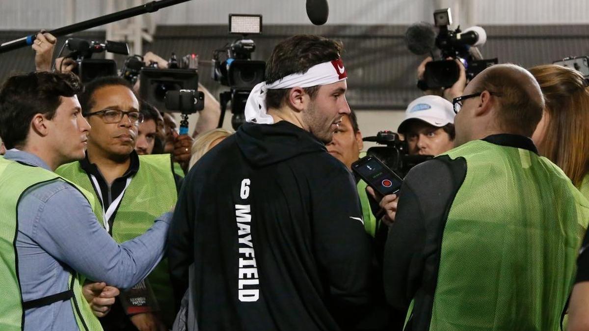 Oklahoma quarterback Baker Mayfield is surrounded by the media following an NCAA college football Pro Day workout in Norman, Okla., on March 14.