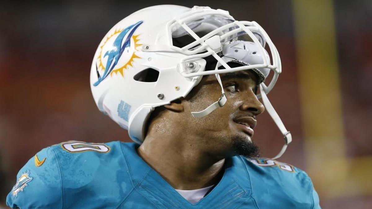 Miami Dolphins defensive end Olivier Vernon (50) looks on from the sidelines during an NFL preseason football game against the Tampa Bay Buccaneers Saturday, Aug. 16, 2014, in Tampa, Fla.