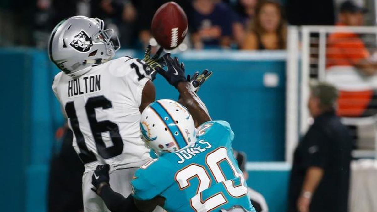 Oakland Raiders receiver Johnny Holton reels in a 44-yard touchdown catch over Reshad Jones.