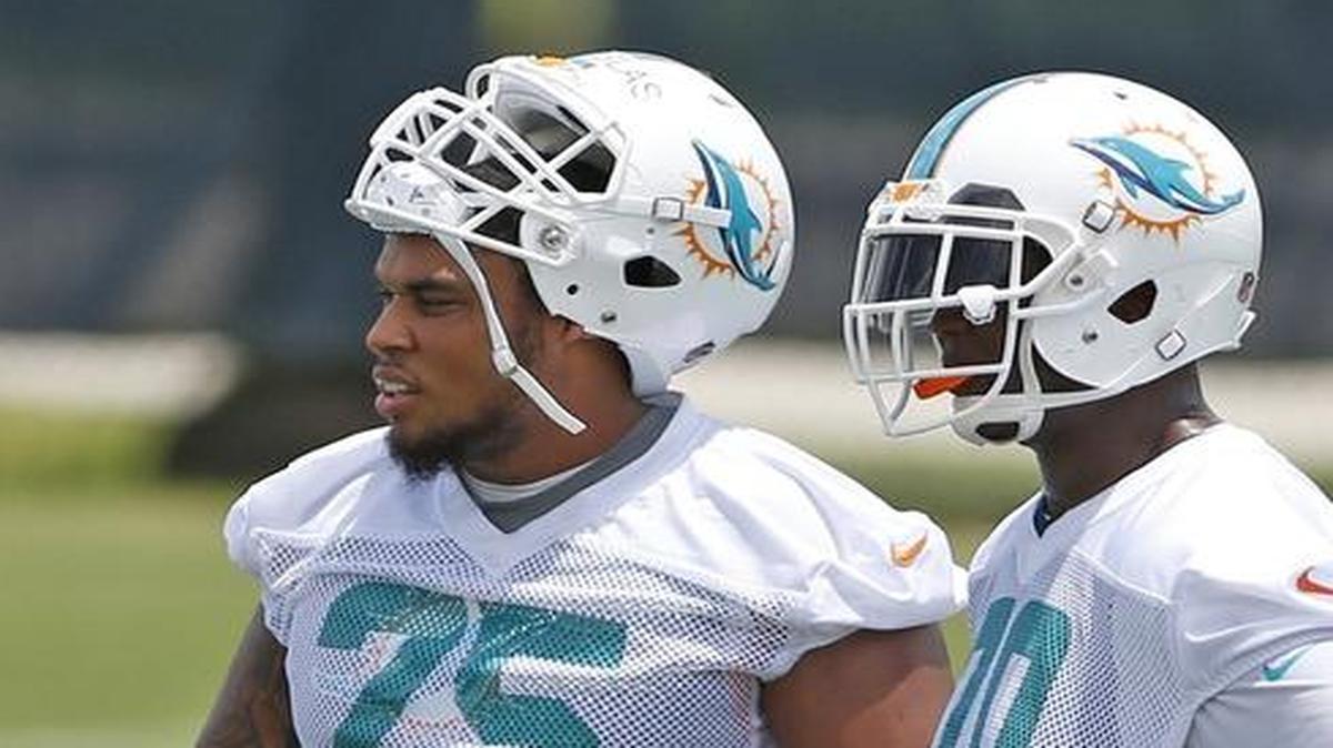 
Jamil Douglas (75) and Ja’Wuan James look on Wednesday at minicamp. Douglas is battling Dallas Thomas to start at left guard. 
