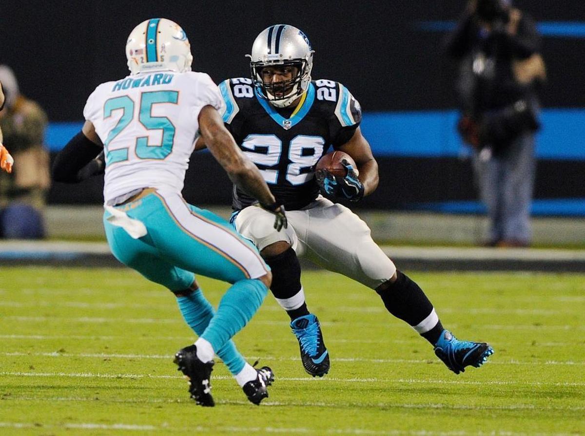 Carolina Panthers running back Jonathan Stewart (28) runs against Miami Dolphins cornerback Xavien Howard (25) in the first half of an NFL football game in Charlotte, N.C., Mon., Nov. 13, 2017.