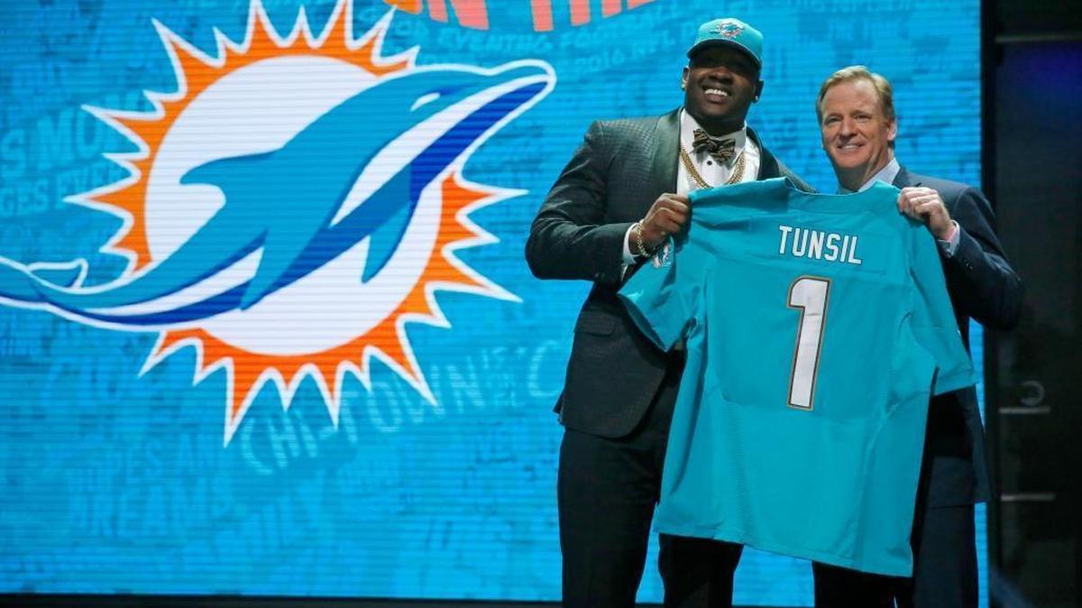 Mississippi’s Laremy Tunsil poses for photos with NFL commissioner Roger Goodell after being selected by the Miami Dolphins as the 13th pick in the first round of the 2016 NFL football draft, Thurs., April 28, 2016, in Chicago.