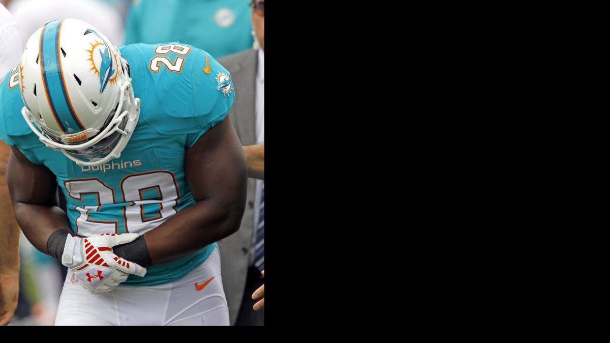 
Miami Dolphins running back Knowshon Moreno (28) is injured in the first quarter against the Buffalo Bills at Ralph Wilson Stadium in Orchard Park, New York, on Sunday, Sept. 14, 2014. 
