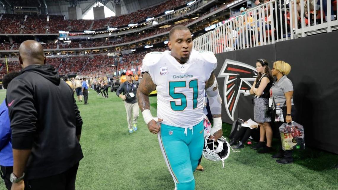 Miami Dolphins center Mike Pouncey (51) leaves the field before halftime during the first half of an NFL football game between the Atlanta Falcons and the Miami Dolphins, Sunday, Oct. 15, 2017, in Atlanta. (AP Photo/David Goldman)