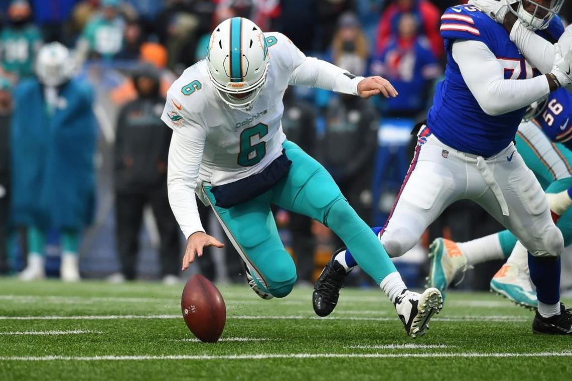 Miami Dolphins quarterback Jay Cutler (6) recovers a fumble during the second half of an NFL football game against the Buffalo Bills Sun., Dec. 17, 2017, in Orchard Park, N.Y. The Bills won 24-16.