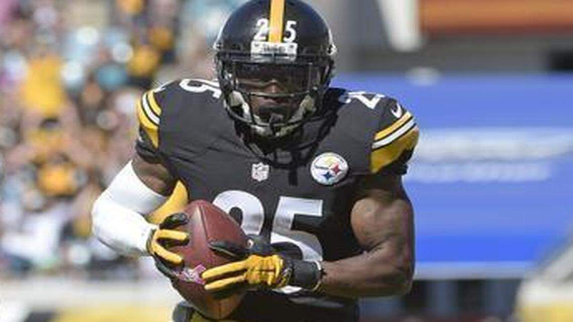 
Pittsburgh Steelers cornerback Brice McCain, right, returns an intercepted pass 22 yards for a touchdown against the host Jacksonville Jaguars on Sunday, Oct. 5, 2014.
