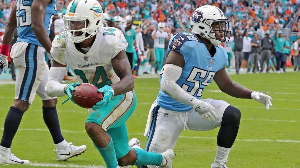 Miami Dolphins Jarvis Landry scores a fourth quarter touchdown as Tennessee Titans Jayon Brown fails defend at Hard Rock Stadium in Miami Gardens, Florida, October 8, 2017.