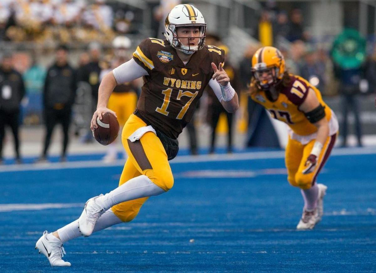 Wyoming quarterback Josh Allen runs with the ball against Central Michigan during the Famous Idaho Potato Bowl last December.