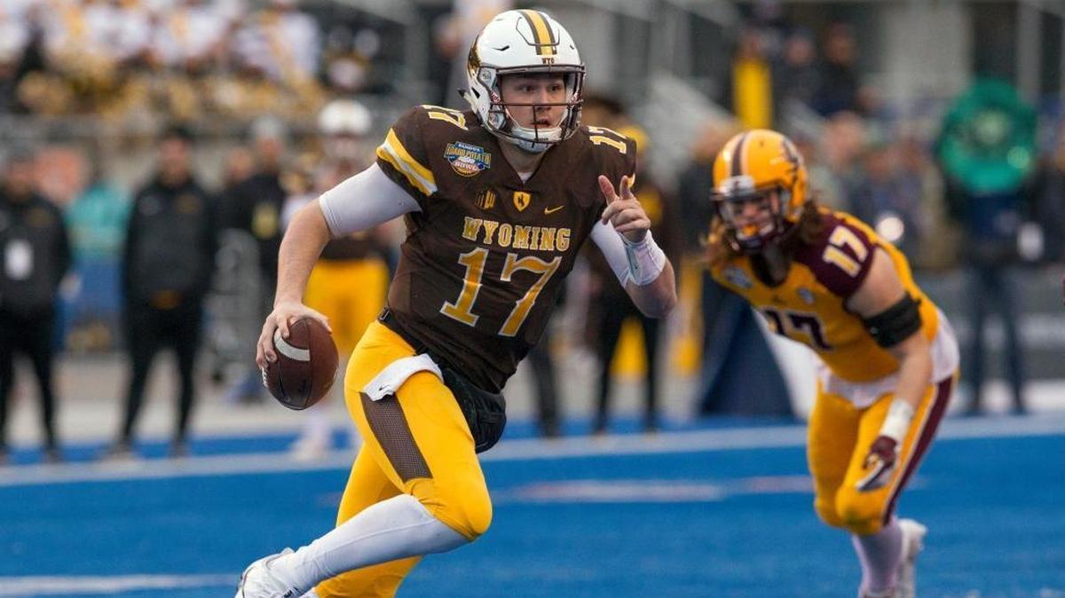 Wyoming quarterback Josh Allen runs with the ball against Central Michigan during the Famous Idaho Potato Bowl last December.