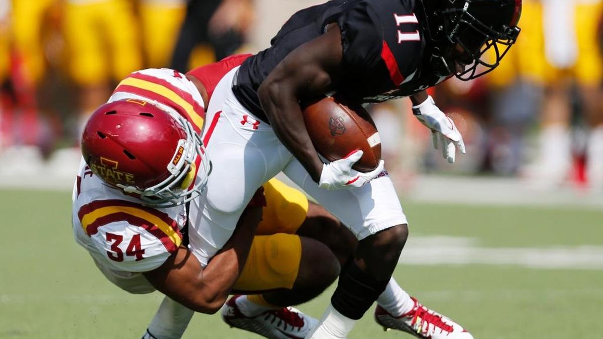Texas Tech's Jakeem Grant is tackled by Iowa State's Nigel Tribune during an NCAA college football game, Saturday, Oct. 10, 2015, in Lubbock, Texas.
