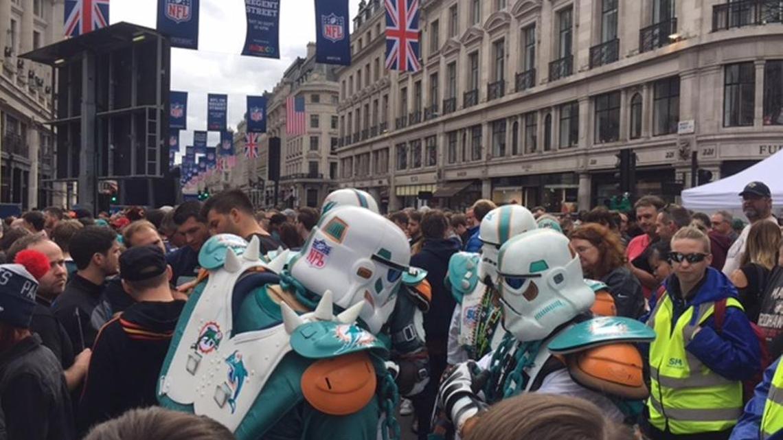 Dolphins fans dressed as storm troopers from the ‘Star Wars’ series mingle with the crowd during an NFL fanfest in London on Saturday. There were footballs available at the fanfest.