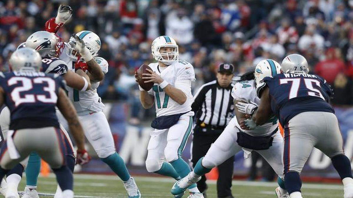 
Miami Dolphins quarterback Ryan Tannehill (17) drops back to pass in the third quarter of the team’s game against the New England Patriots at Gillette Stadium in Foxborough, Mass. on Dec. 14, 2014
