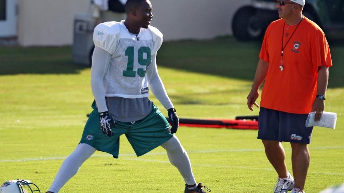 Miami Dolphins receiver Brandon Marshall talks to coach Tony Sparano during practice in Davie on Tuesday, Aug. 17, 2010.