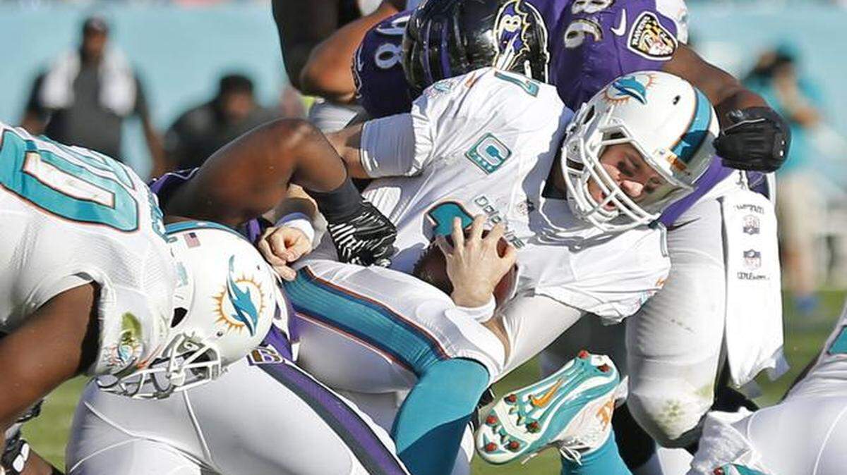 
Miami Dolphins quarterback Ryan Tannehill (17) is sacked late in the fourth quarter as the Miami Dolphins host the Baltimore Ravens at Sun Life Stadium in Miami Gardens on Sunday, Dec. 7, 2014
