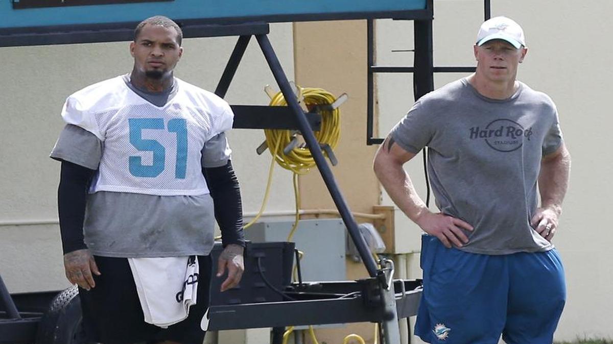 Miami Dolphins center Mike Pouncey, 51, looks on during NFL football minicamp, Thurs., June 15, 2017, at the team's training facility in Davie.