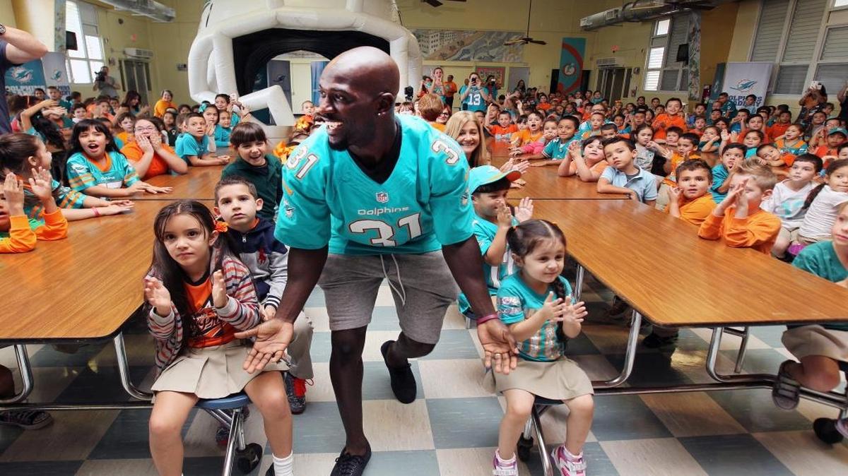 Michael Thomas is a student as well as a mentor. He will graduate from the University of Miami with a business degree Thursday.