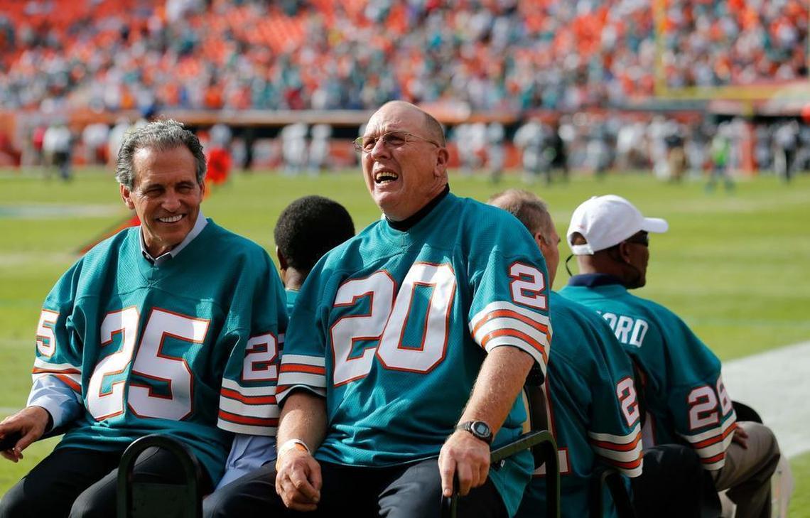 Former Miami Dophins’ team of 1972, Tim Foley (25) and Larry Seiple (20) are driven on the field for a halftime appreciation during an NFL football game against the Jacksonville Jaguars, Sun., Dec. 16, 2012, in Miami.