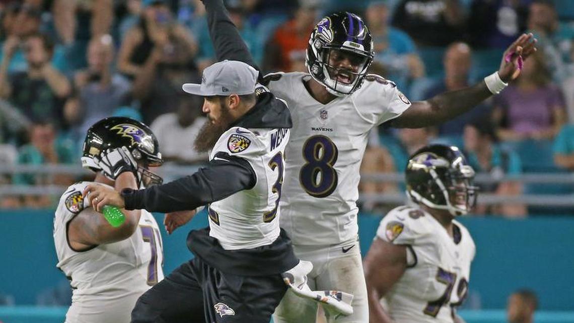 Baltimore Ravens quarterback Lamar Jackson celebrates with teammate safety Eric Weddle (32) after his touchdown pass to wide receiver DeVier Posey during fourth quarter of an NFL preseason football game against the Miami Dolphins at Hard Rock Stadium on Saturday, Aug. 25, 2018, in Miami Gardens.