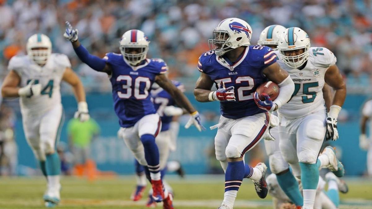 
Bills linebacker Preston Brown intercepts a pass by Dolphins quarterback Ryan Tannehill and returns it 44 yards for a touchdown Sunday. Tannehill threw three interceptions. 
